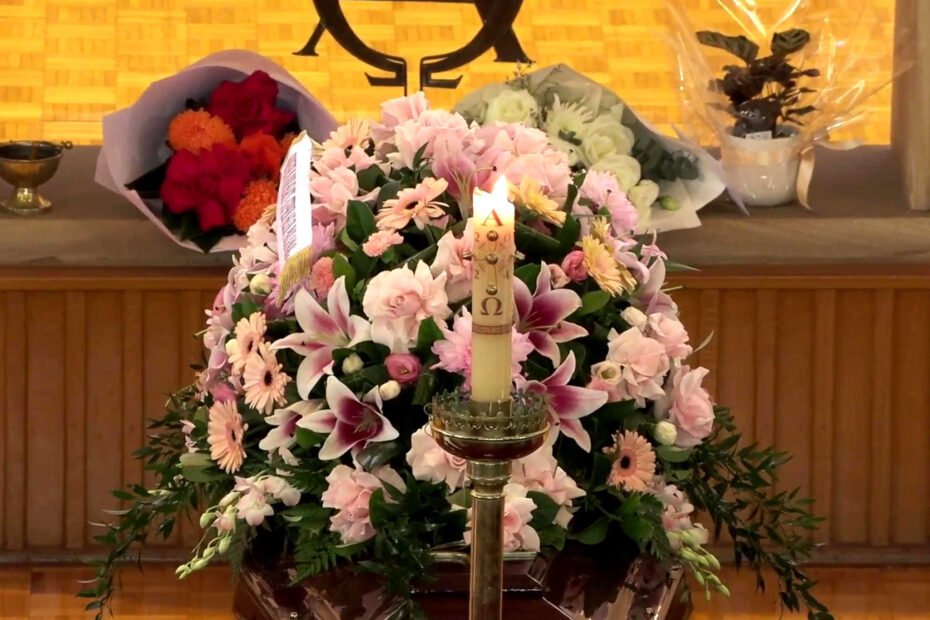 Casket and Flowers and Candle